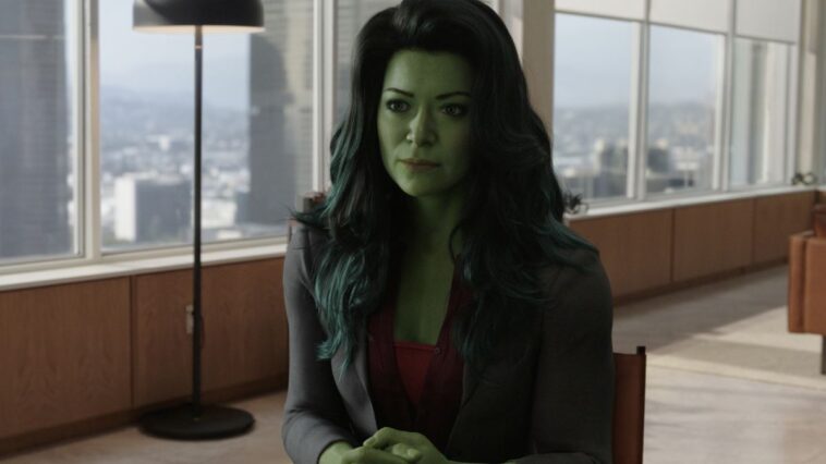 She-Hulk looks at someone off camera as she sits in an office room in her MCU TV series