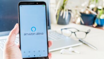 Beer Sheva, Israel.  29 de diciembre de 2020: Mano sosteniendo un móvil con el logotipo de Amazon Alexa en la pantalla.