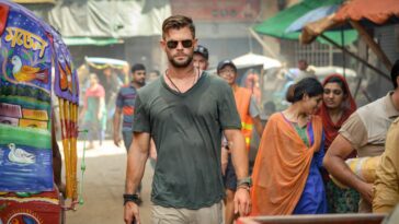 Chris Hemsworth walking down a street in Netflix