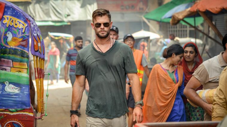 Chris Hemsworth walking down a street in Netflix