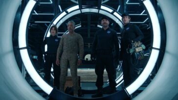 Leo and some other crewmates stand in a vault in Netflix