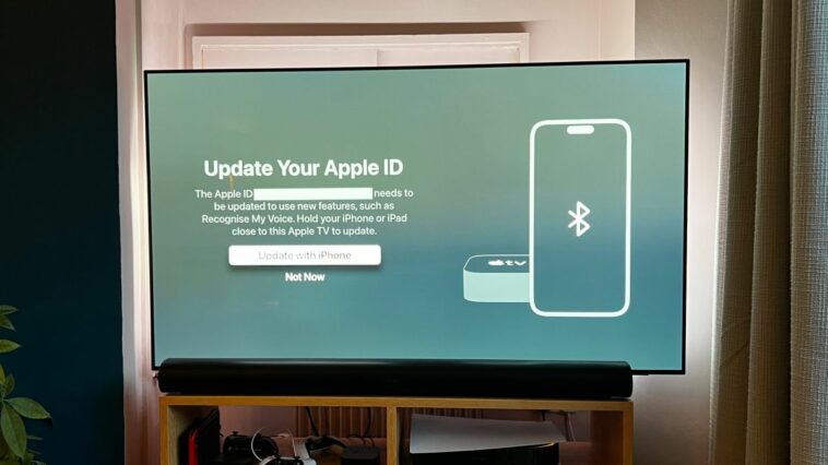 A TV showing a message requesting that an iPhone be used to accept Apple TV terms and conditions