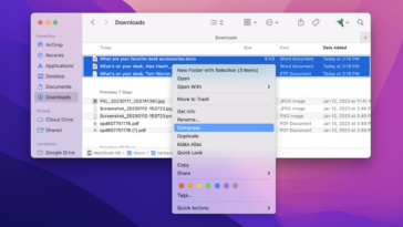 Una aplicación Finder en una Mac con tres archivos resaltados y un menú desplegable con Compress resaltado.