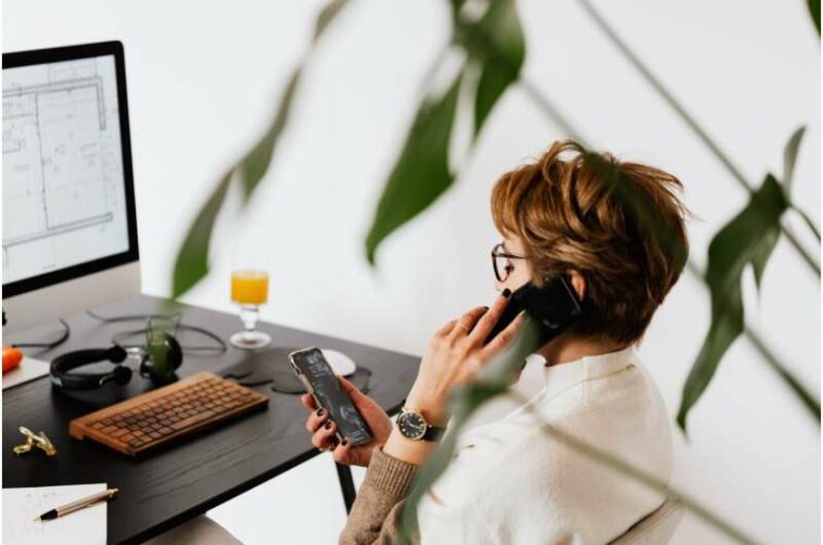 mujer en llamada telefónica en el trabajo