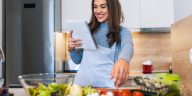 Mamá leyó cuidadosamente una receta mientras prepara una comida.